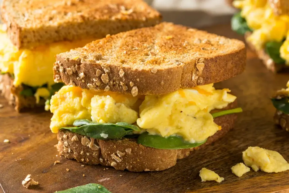 Scrambled eggs with sautéed spinach and whole-grain toast