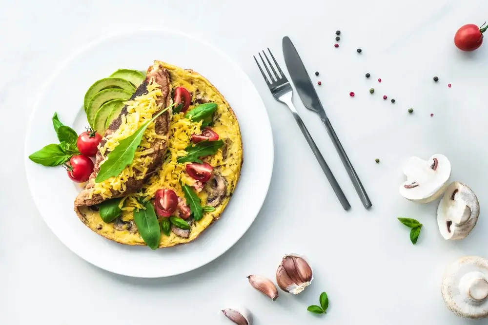 Vegetable omelet with spinach, mushrooms, tomatoes,
