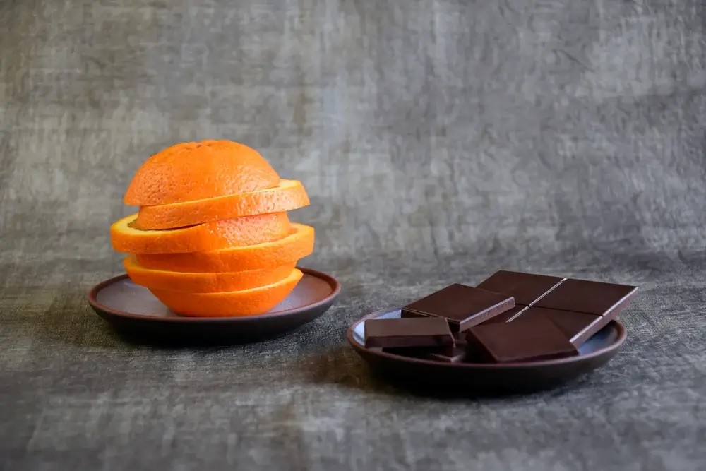 Orange slices and a small square of dark chocolate