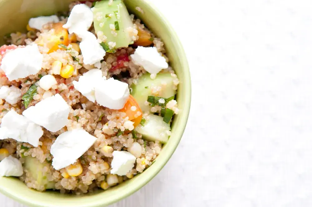 Quinoa salad with cucumbers, tomatoes, olives, and feta